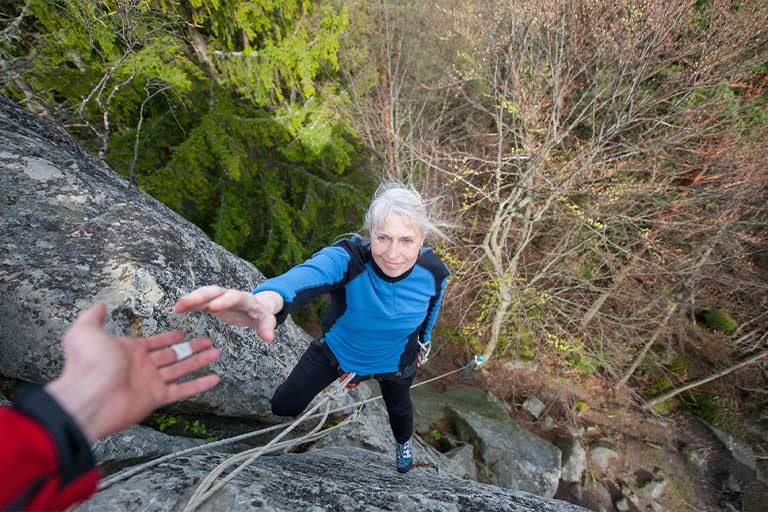 A male climber helping a female climber